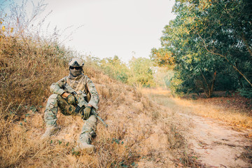 Closeup asian soldier with weapons in hand at the forest,prepare for maneuver,military veterans...