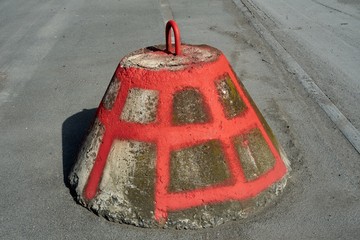 Weathered Concrete Traffic Barrier with Red Grid Pattern