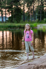 Young girl in the evening on the lake