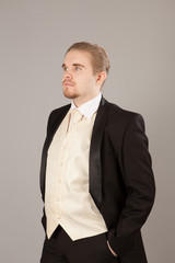 Portrait of handsome young man in a tuxedo. Fashionable clothing for the festive evening