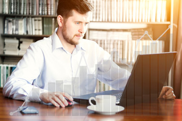 Increase charts and graphs as concept of growing stock finance markets. Young caucasian bearded businessman working in luxury office with computer.