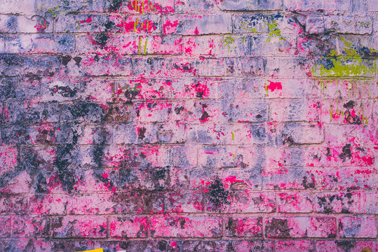 Old brick wall carelessly painted in pink - grunge background