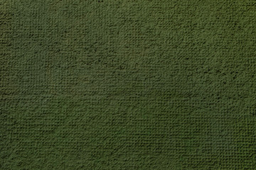 Cement or plaster wall. Green background.