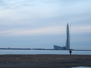 skyscraper standing on the shore of a frozen bay