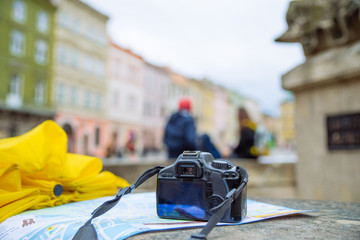 travel concept. camera on the map with blurred town on background