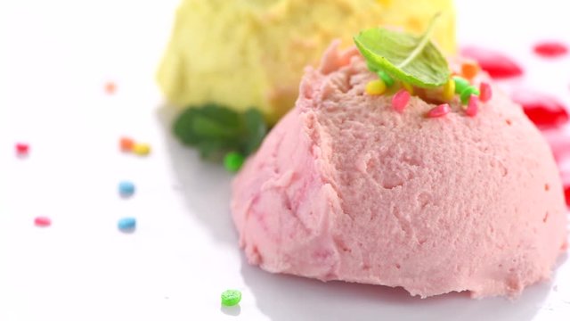 Ice cream. Strawberry or raspberry, banana or lemon flavor icecream rotated. Sweet dessert decorated with colorful sprinkles closeup. 4K UHD video footage. 3840X2160