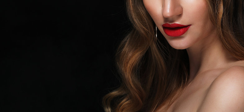 Close-up shot of beautiful woman face with red lips