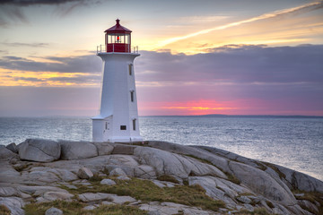 Sunset behind the lighthouse at Peggy's Cove near Halifax, Nova Scotia Canada. - Powered by Adobe