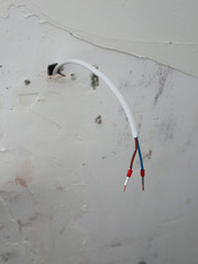 cable lugs on a double wire sticking out of the wall