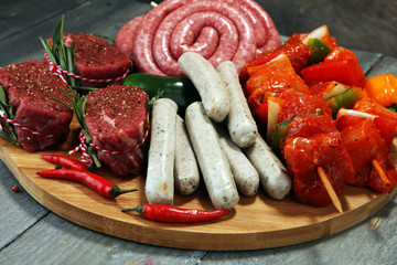 Selection of marinaded meat for bbq grilling with herbs on table