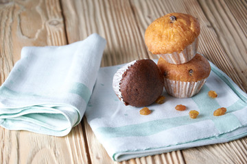 Tasty muffins arranged in pattern on light textured background, close-up, shallow depth of field, selective focus.