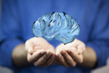 businessman holding digital image of brain in palm