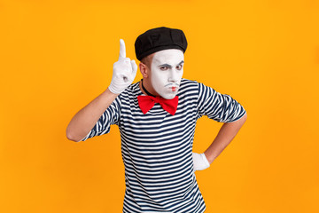 Mime man showing one finger up. Last chance
