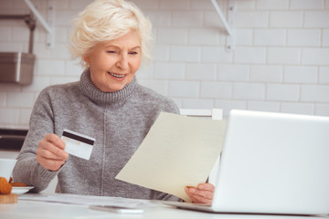 Businesswoman keeps a credit card and reads a contract for purchase house