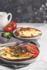 Delicious bright egg omelet with cheese and vegetables. Breakfast food concept, dark background