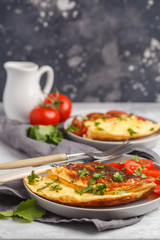 Delicious bright egg omelet with cheese and vegetables. Breakfast food concept, dark background