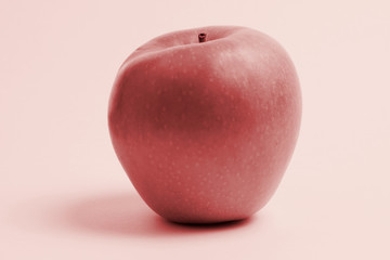 Photo of a red apple on a red background