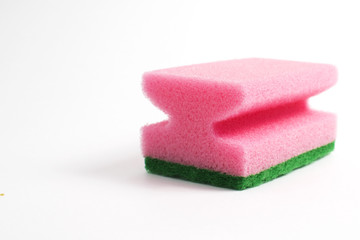 Obraz na płótnie Canvas Photo of a dish sponge that consists of pink foam and green abrasive on a white background