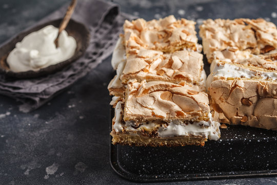 Sliced Cake With Meringue And Whipped Cream, Dark Background