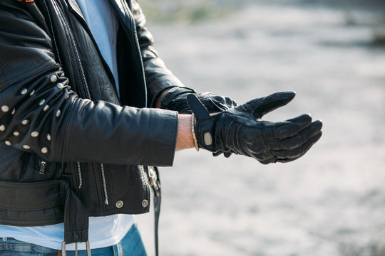 Biker Putting On Leather Gloves To Drive His Motorbike