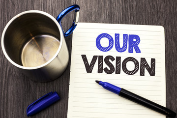 Conceptual hand writing showing Our Vision. Business photo showcasing Innovation Strategy Mission Goal Plan Dream Aim Direction written on Notebook Paper wooden background Marker and Cup