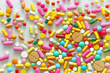 Fototapeta na wymiar Colorful pills on a light grey background