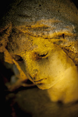 Close up face of sad guardian angel. (fragment of an antique statue)