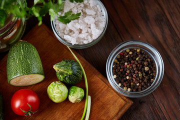 fresh vegetables on the cutting board over wooden background, selective focus, shallow depth of field