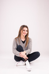 Happy student sitting on the floor isolated on white background