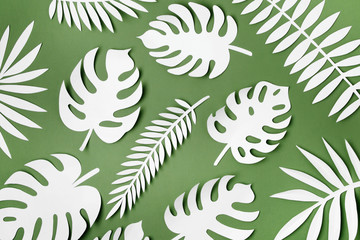 Fototapeta na wymiar Tropical leaves pattern. Various paper leaves on green background. Paper art. Flat lay, top view