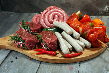 Selection of marinaded meat for bbq grilling with herbs on table