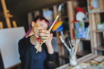 Selective focus on female artist dirty hands