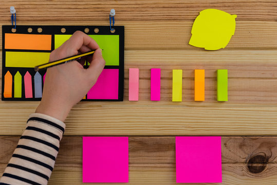 Note book and post-it notes on wooden background