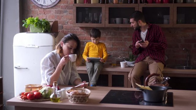 Young family spanding time with gadgets