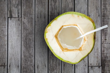 Coconut juice on wooden table.Top view