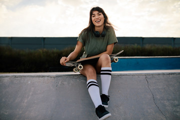 Attractive woman sitting on ramp at skate park © Jacob Lund