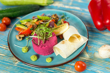Vegetable vegetarian salad in a blue plate