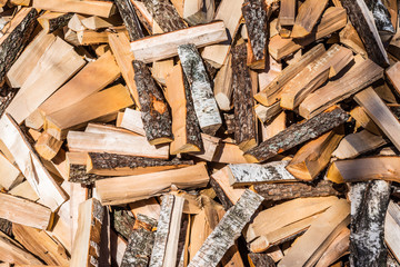chaotically arranged in a pile of fresh chopped firewood, abstract background