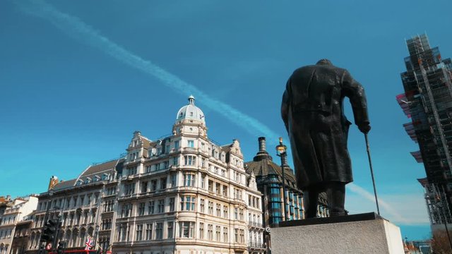 Conservation works on Big Ben: A wide angle shot of Westminster, London, England, UK, featuring the statue of Winston Churchill and an unrecognizable Big Ben surrounded by scaffolding