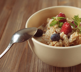 Oatmeal with fresh berries and nuts close up