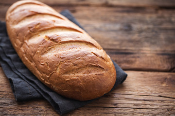 Fresh bread on wooden table. Top view with space for your text