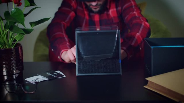 4k Young Man Unwrapping New Smart Home Device