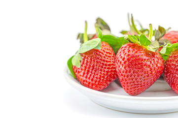 fresh strawberries on plate on white background