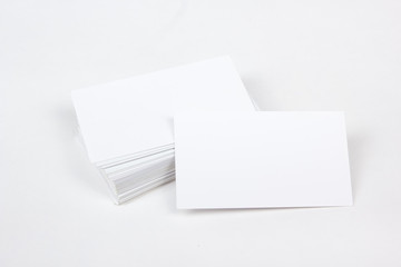 Mockup of business cards fan stack at white textured paper background.