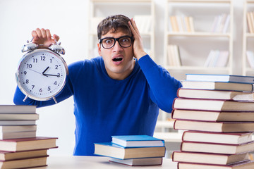 Male student preparing for exams in college library