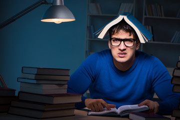 Student preparing for exams late at night in library