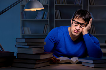 Student preparing for exams late at night in library