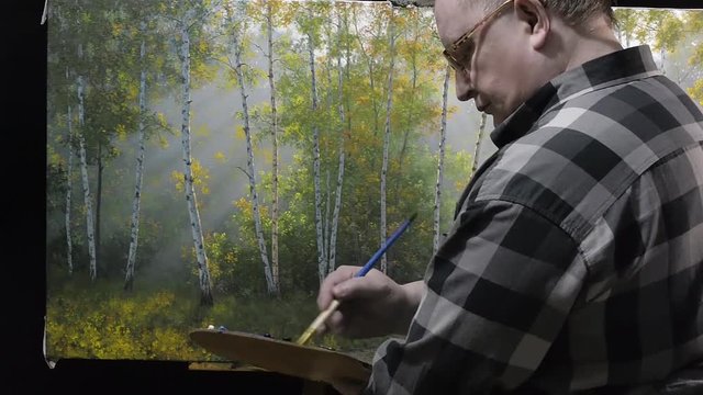 Artist working on painting