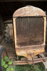 Hand cranked tractor in barn