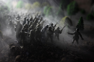 War Concept. Military silhouettes fighting scene on war fog sky background, World War Soldiers Silhouettes Below Cloudy Skyline At night. Attack scene. Selective focus Tanks battle. Decoration